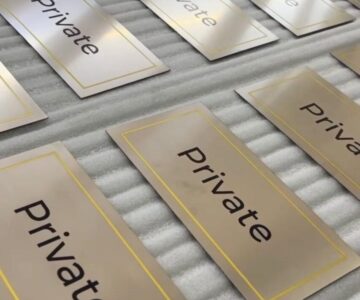 Premium metallic “Private” name board with gold border finish for office and commercial door signage by Lumiere Sign Company
