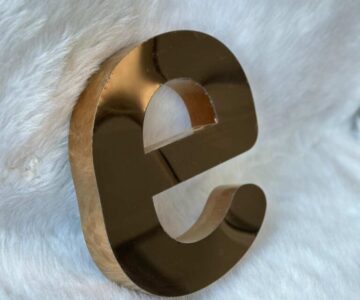 Premium titanium gold 3D letter signage with polished metallic finish for luxury brand and showroom displays