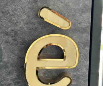 Premium gold lip letter signage with white acrylic face manufactured by Lumiere Sign Company Kochi for luxury brand name boards